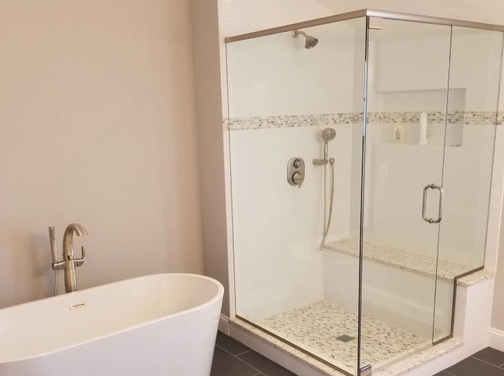 newly remodel bathroom with bathtub installed and glass shower area